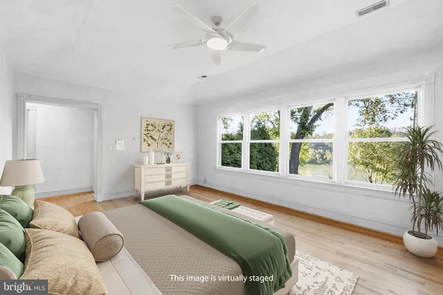 a bedroom with furniture and a large window