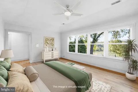 a bedroom with furniture and a large window