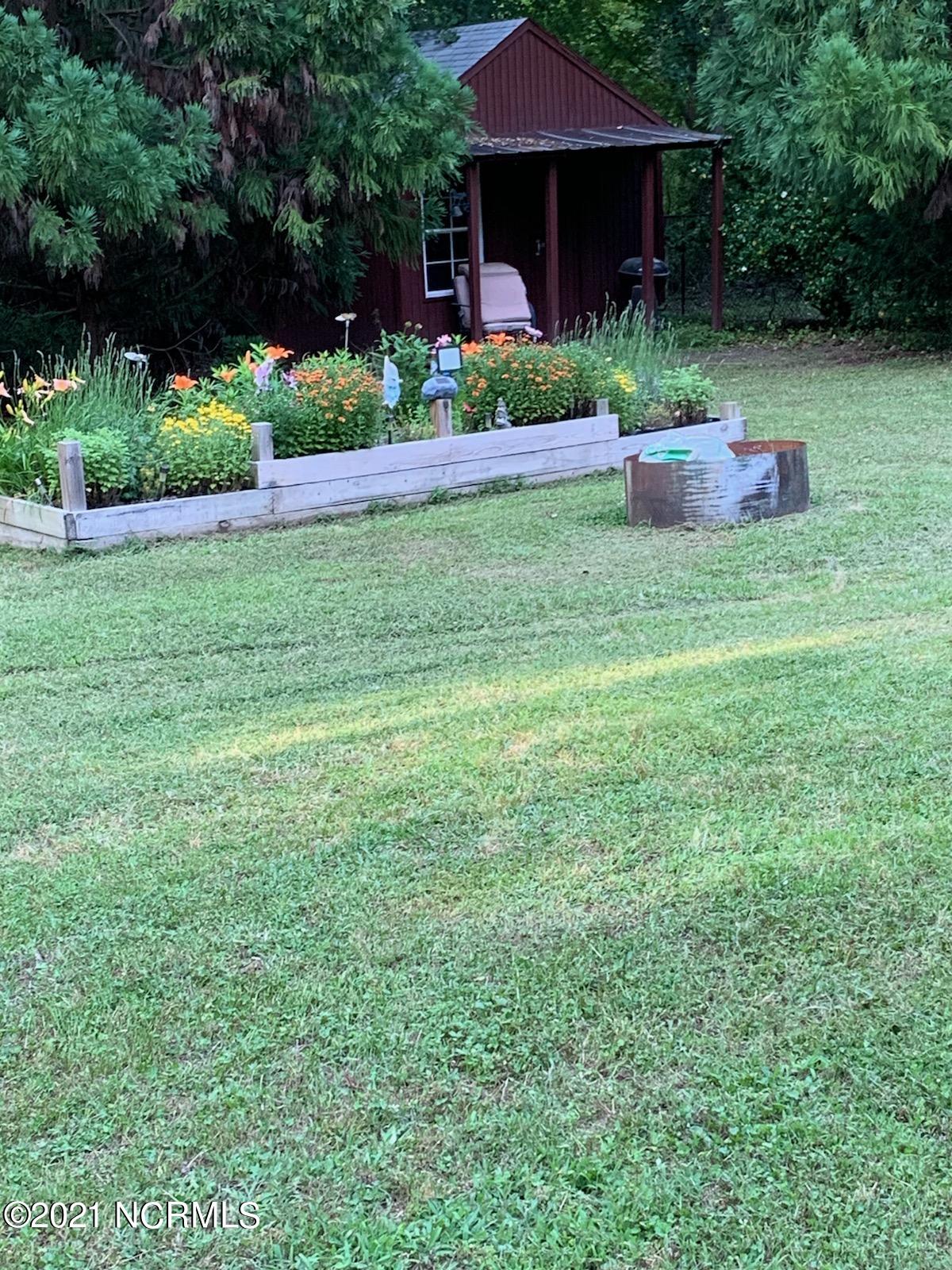 7654 Heritage Road Spring Hope, NC 27882 - Photo 32 of 37 spingtime flower bed & work shed