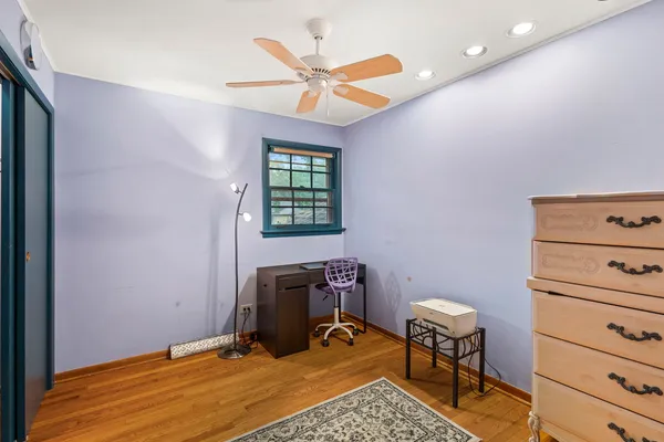 a workspace with wooden floor and a window