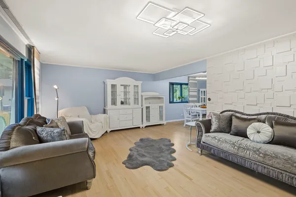 a living room with furniture and a chandelier