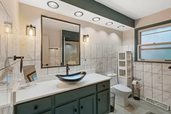 a bathroom with a toilet sink and shower