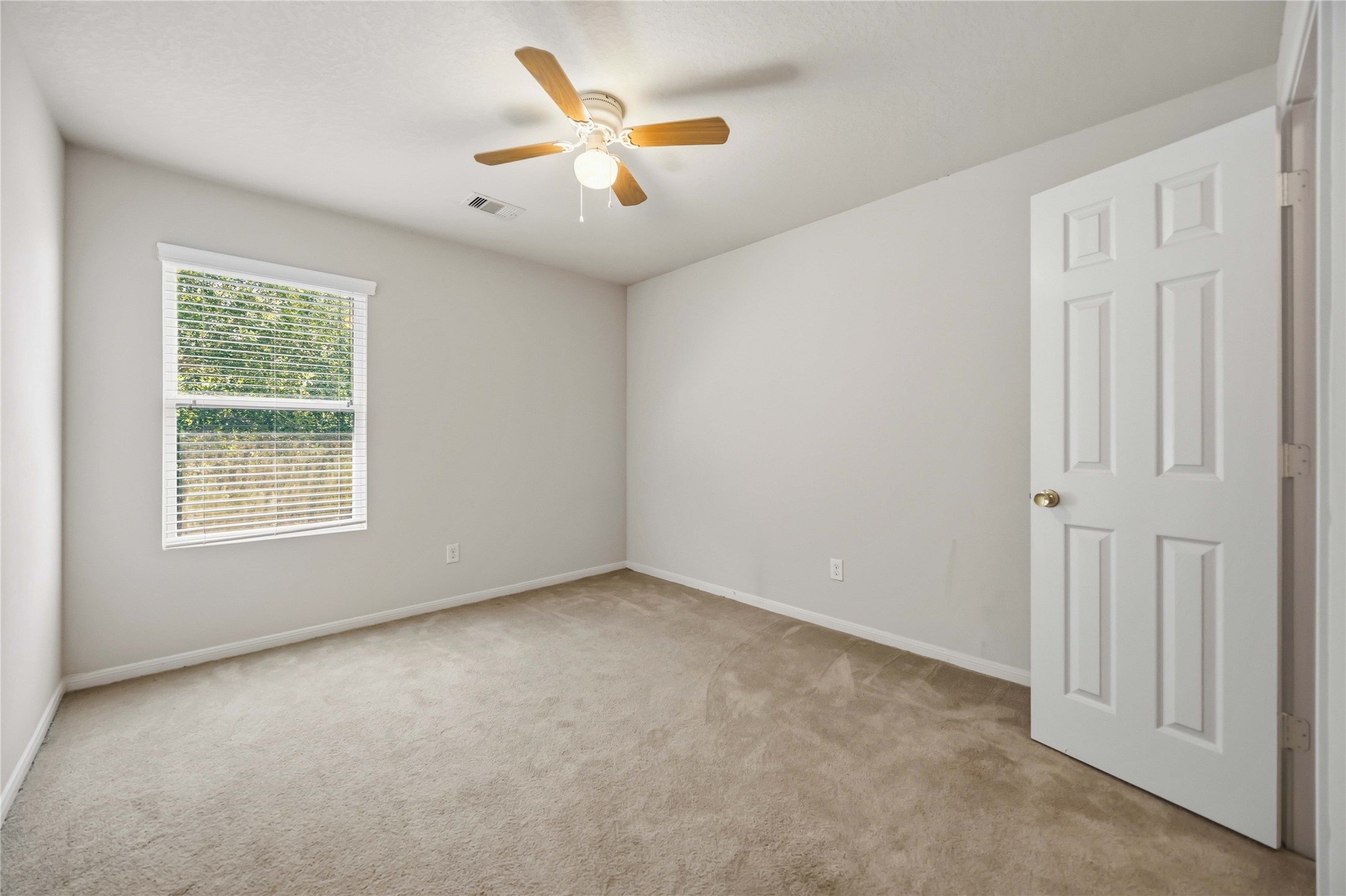29526 Winton Wood Way Spring, TX 77386 - Photo 21 of 29 Bright secondary bedroom with a ceiling fan, generous closet, and natural light.