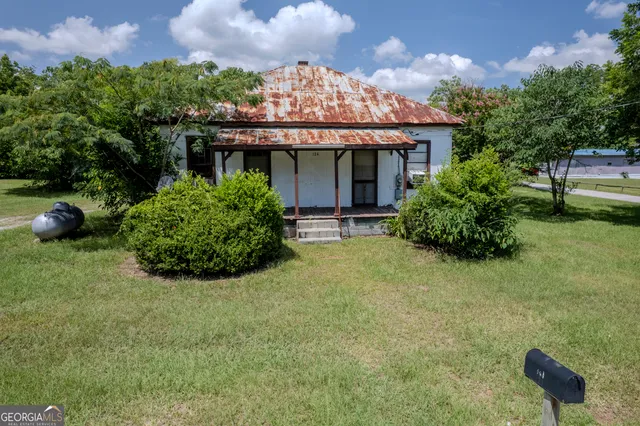 a view of a house with a garden and plants