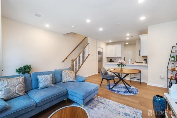 a living room with furniture and kitchen view