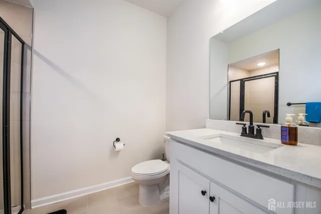a bathroom with a sink a toilet and mirror