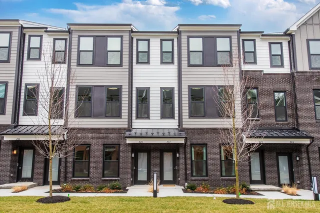 a front view of a building with windows yard