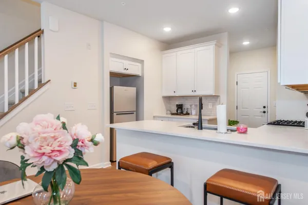 a kitchen with stainless steel appliances kitchen island granite countertop a sink and cabinets