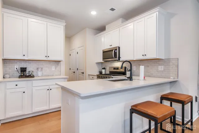 a kitchen with appliances a sink and cabinets