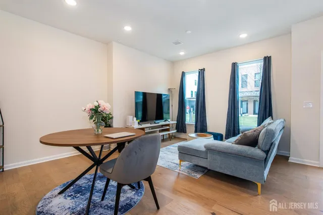 a living room with furniture potted plant and a flat screen tv