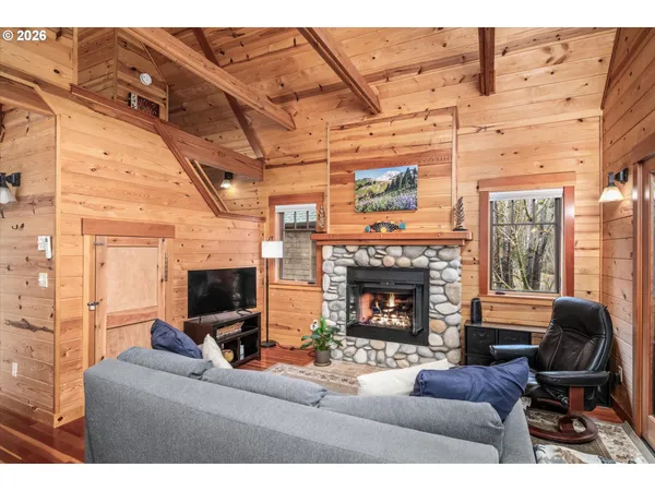 a living room with furniture a flat screen tv and a fireplace