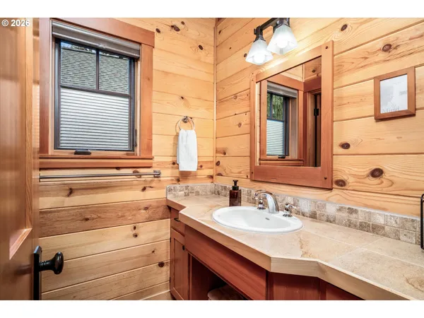 a bathroom with a sink vanity and a mirror