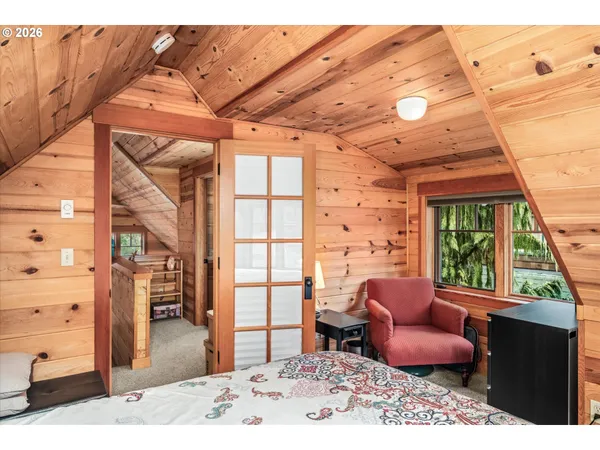 a living room with furniture a rug and a large window