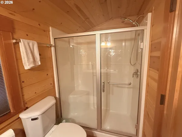 a bathroom with a shower and a toilet