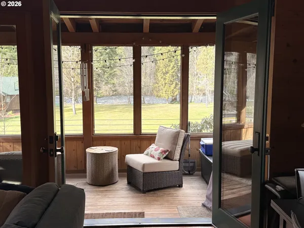 a living room with furniture and floor to ceiling windows