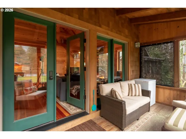 a living room with furniture and a floor to ceiling window