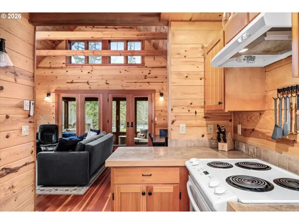 a open kitchen with stainless steel appliances granite countertop a stove and white cabinets