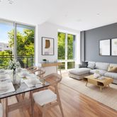 a living room with furniture and large windows