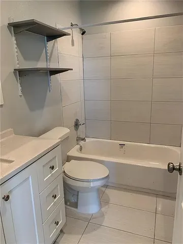a bathroom with a toilet a sink and bathtub