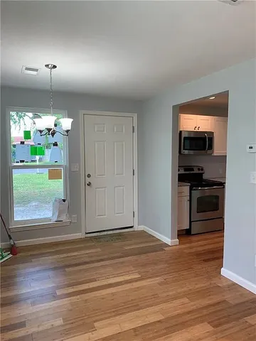 a view of a kitchen from the hallway with a kitchen and a window