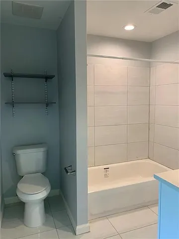 a bathroom with a toilet and bathtub