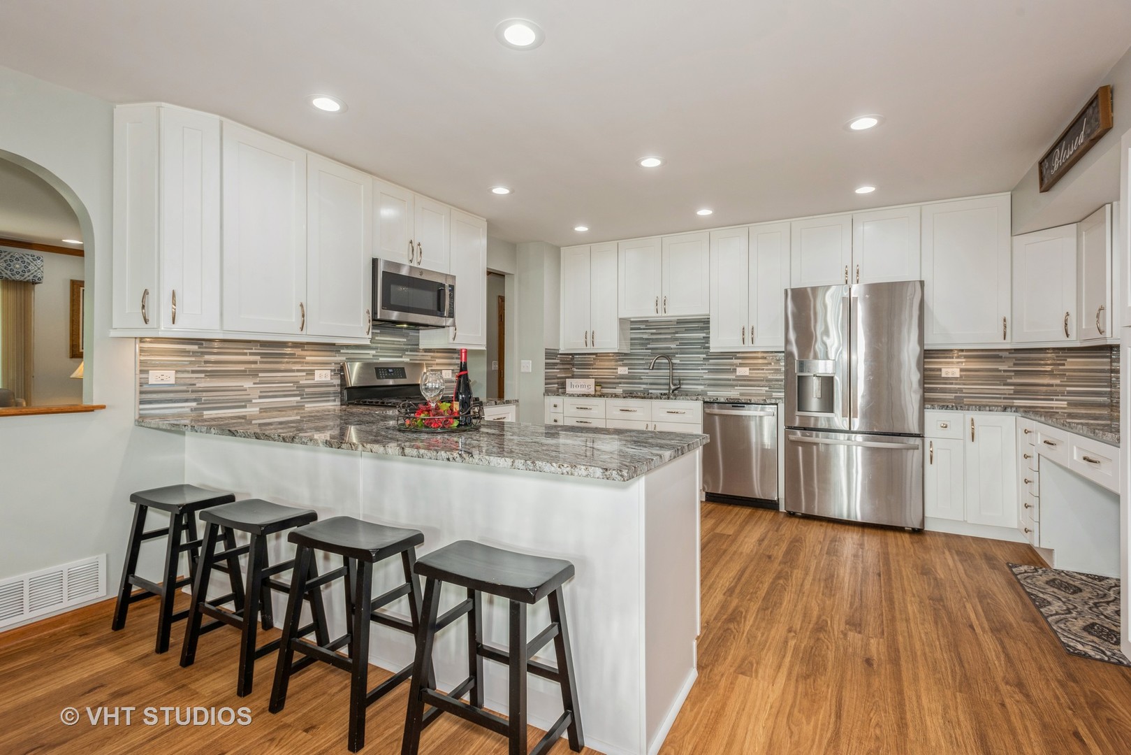 17W347 Forestview Road Bensenville, IL 60106 - Photo 5 of 25 a kitchen with granite countertop stainless steel appliances a refrigerator a stove top oven a sink and cabinets