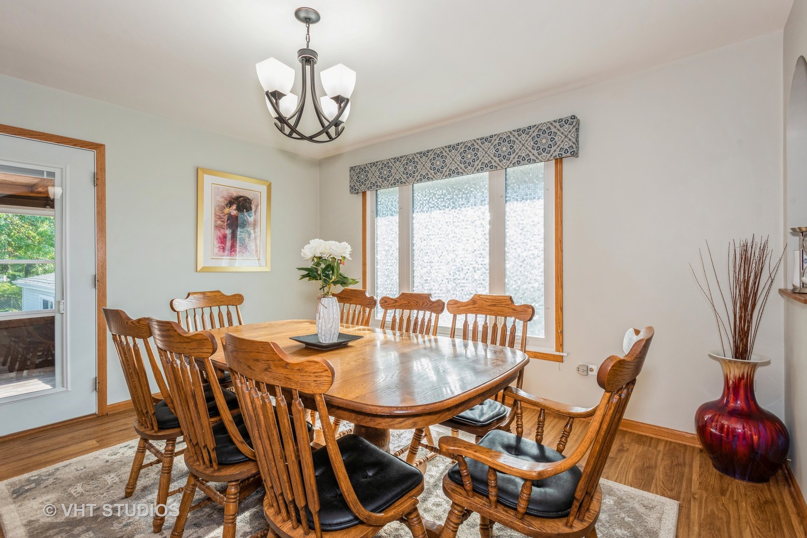 17W347 Forestview Road Bensenville, IL 60106 - Photo 7 of 25 a dining room with furniture a potted plant and a chandelier