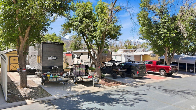 416 Kari Parowan, UT 84761 - Photo 5 of 14 Paved parking area with mature trees providing shade