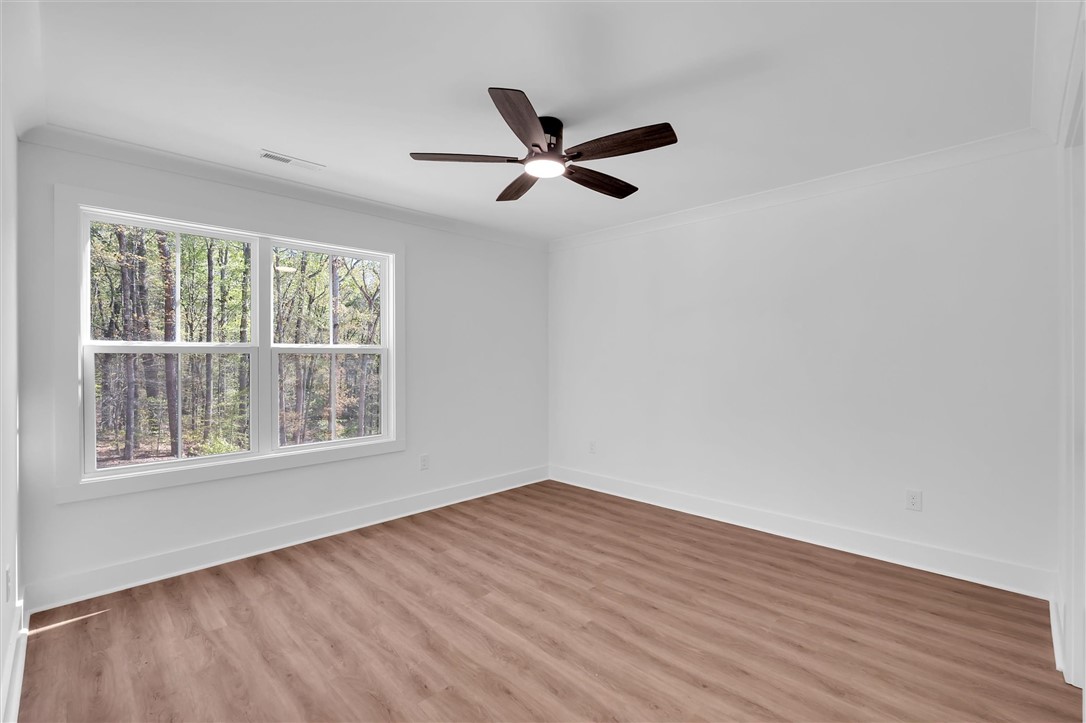407 Blue Ridge Court Westminster, SC 29693 - Photo 29 of 48 Bright and airy bedroom with expansive window and modern ceiling fan.