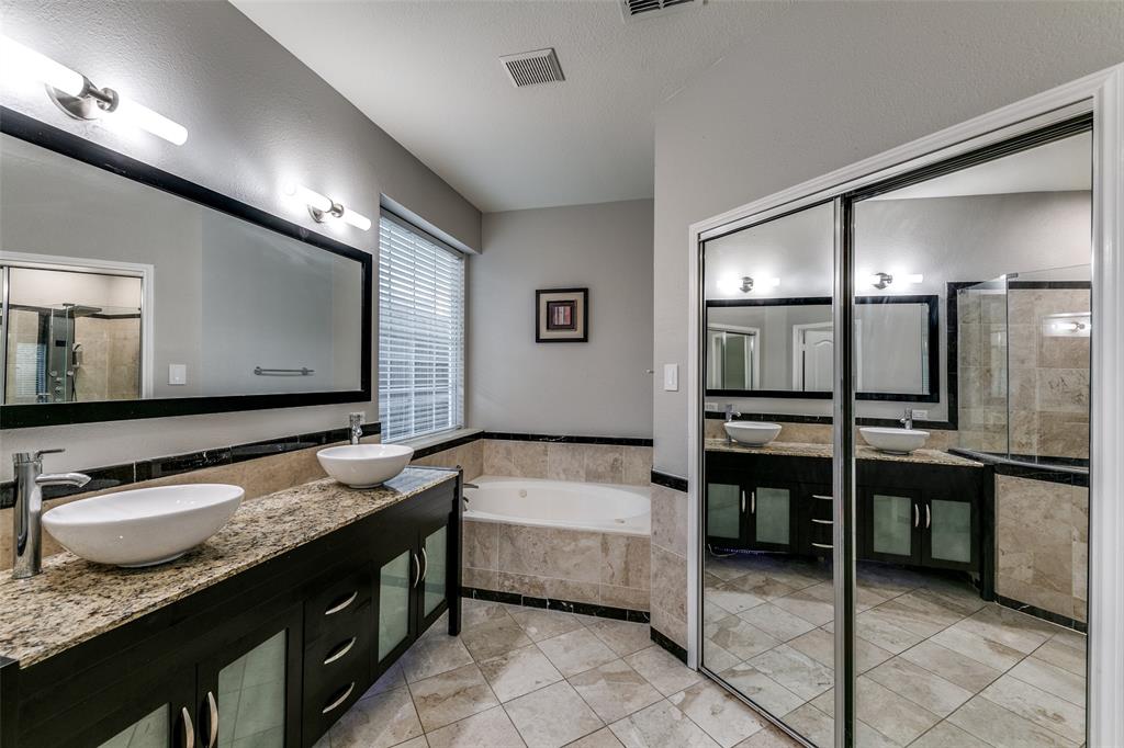 4532 Crown Ridge Drive Plano, TX 75024 - Photo 19 of 25 Bathroom featuring a double vanity with vessel sinks, granite countertop, and dark wood-finish cabinetry
