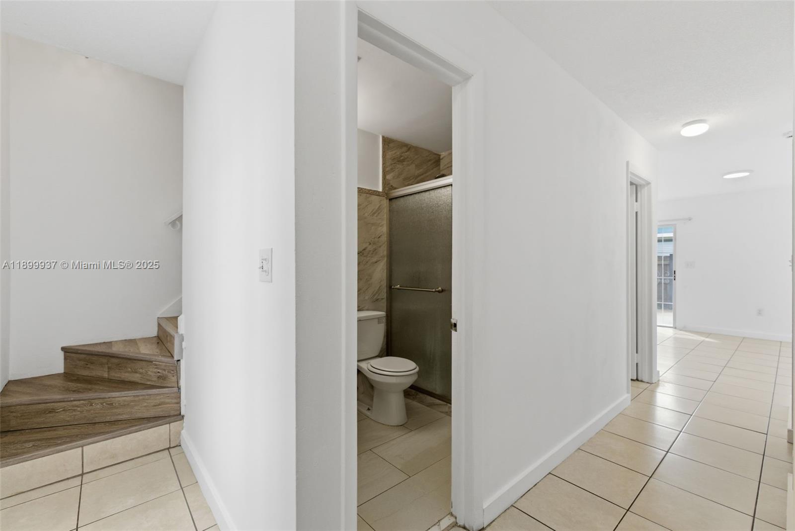 624 Northwest 11th Street, Unit 624 Miami, FL 33136 - Photo 13 of 30 a bathroom with a granite countertop sink and a toilet