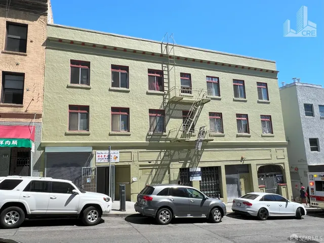 a view of a cars park in front of a building