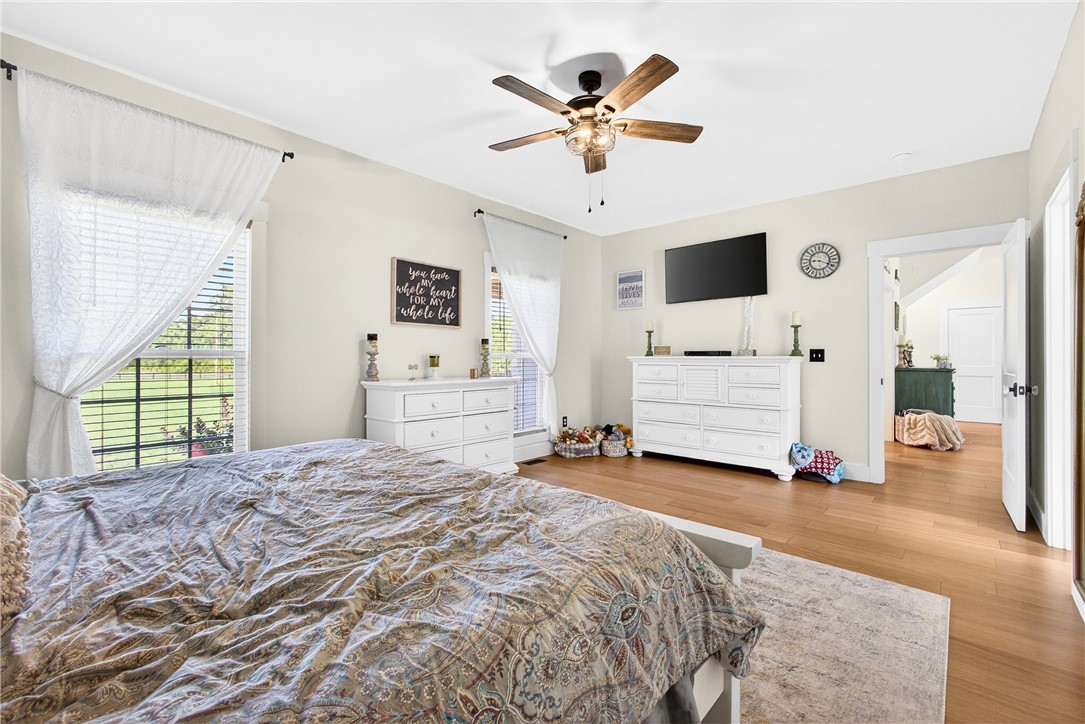 5016 Copeland Road Belton, SC 29627 - Photo 17 of 45 Hardwood floors and a ceiling fan enhance comfort in this well-lit primary bedroom.
