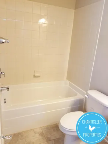 a bathroom with a toilet and a bathtub