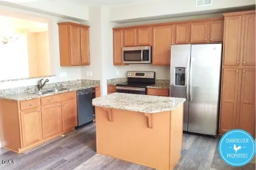 a kitchen with stainless steel appliances granite countertop a refrigerator stove microwave and sink