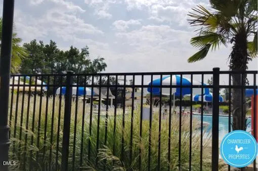 a view of a roof deck with table and chairs