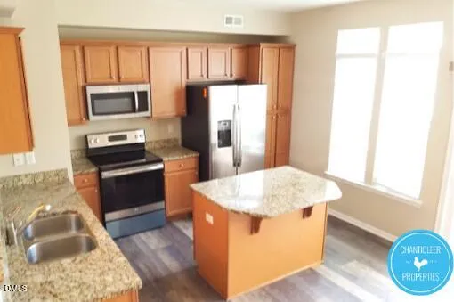 a kitchen with a sink stove and refrigerator