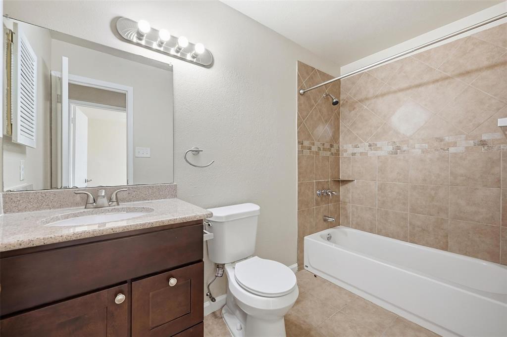4526 Carr Street The Colony, TX 75056 - Photo 14 of 19 a bathroom with a sink a toilet and a bathtub