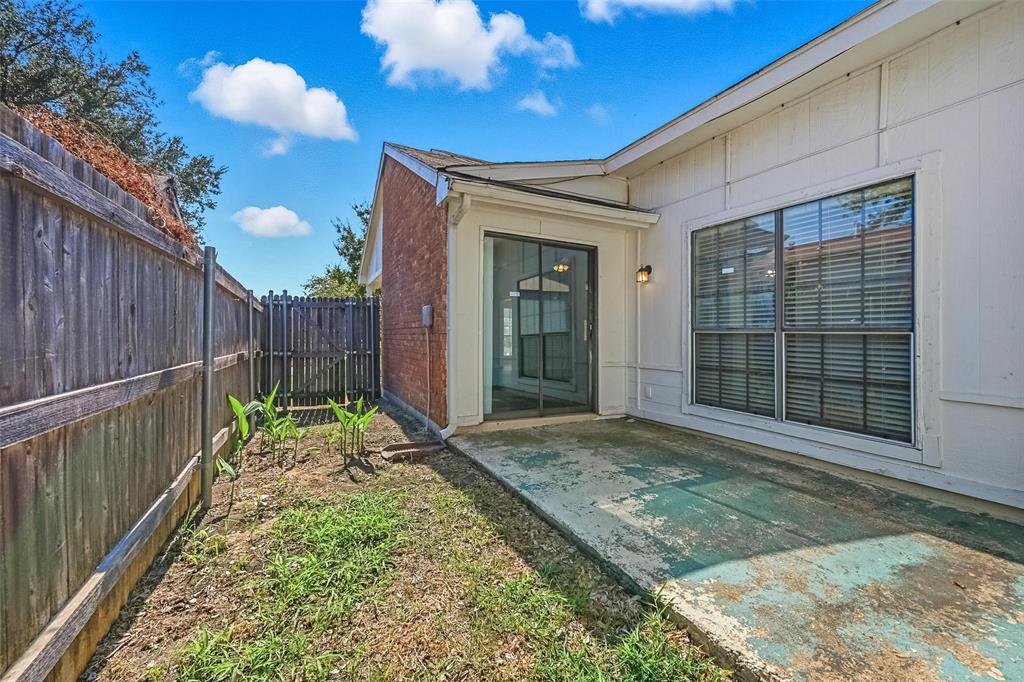 4526 Carr Street The Colony, TX 75056 - Photo 15 of 19 a view of a backyard with table and chairs and wooden fence