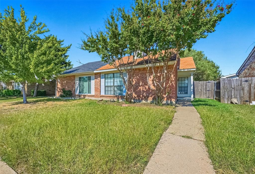 4526 Carr Street The Colony, TX 75056 - Photo 17 of 19 a front view of a house with garden