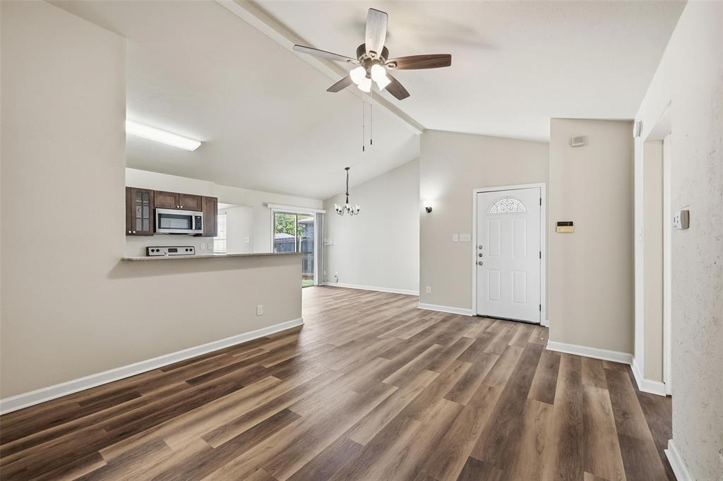 4526 Carr Street The Colony, TX 75056 - Photo 2 of 19 wooden floor in an empty room with a window
