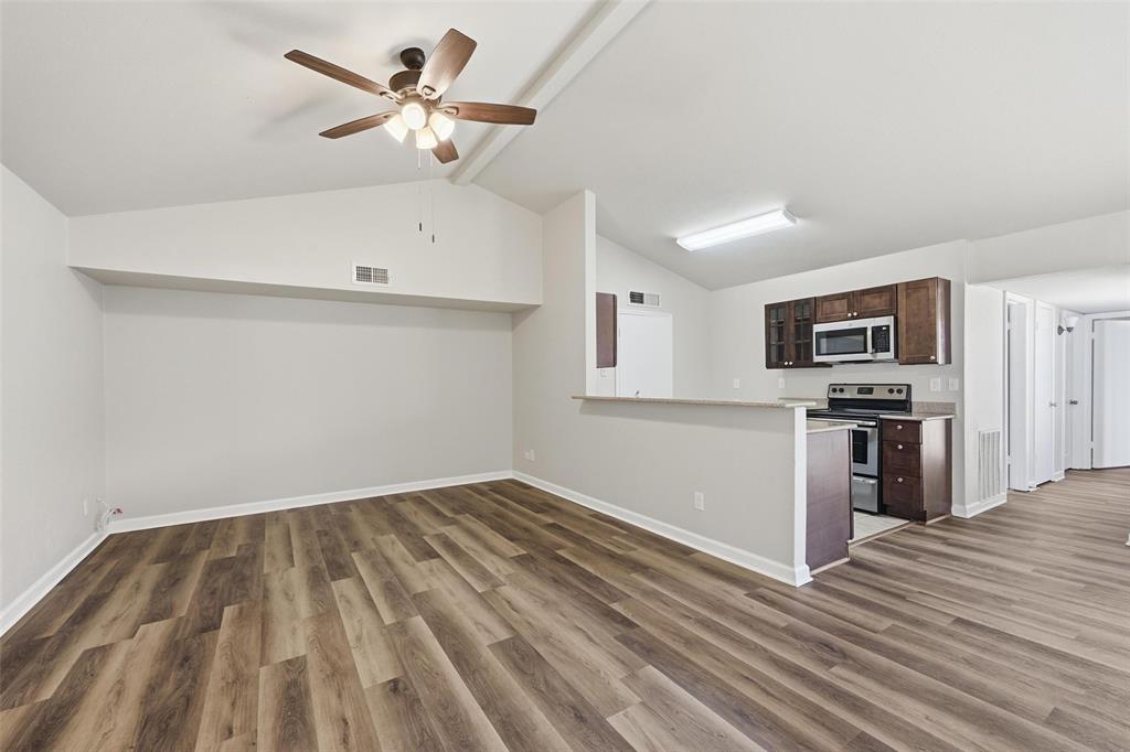 4526 Carr Street The Colony, TX 75056 - Photo 5 of 19 a view of kitchen with wooden floor electronic appliances and window