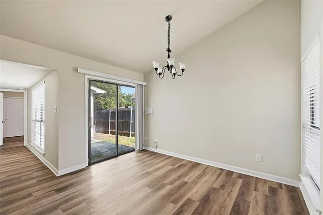 a view of kitchen with wooden floor electronic appliances and window
