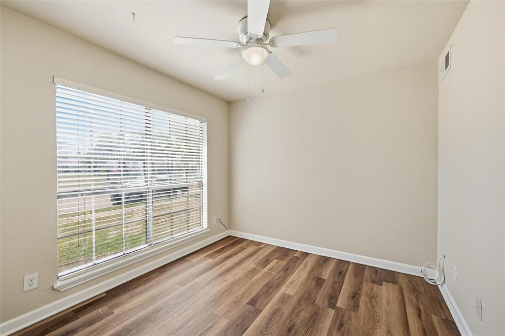 4526 Carr Street The Colony, TX 75056 - Photo 7 of 19 wooden floor in an empty room with a window