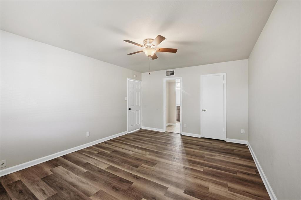 4526 Carr Street The Colony, TX 75056 - Photo 8 of 19 a view of a room with wooden floor and a ceiling fan