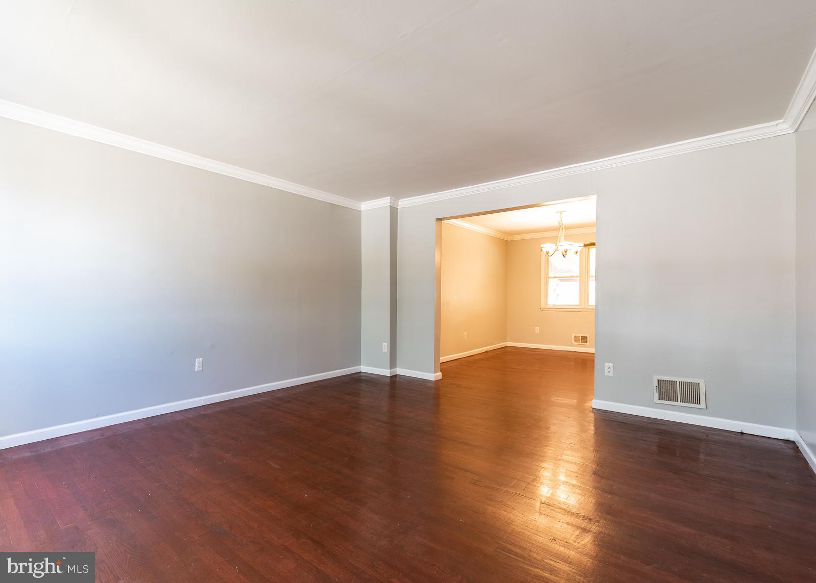 5747 Utrecht Road Baltimore, MD 21206 - Photo 9 of 25 Living room opens to dining room with wood floors