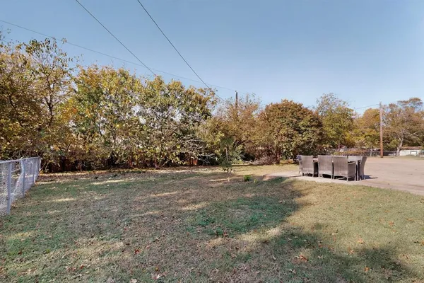 a view of a big yard with large trees