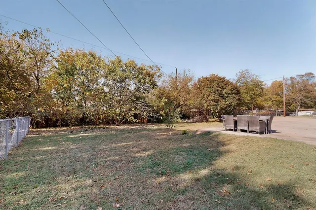 a view of a big yard with large trees