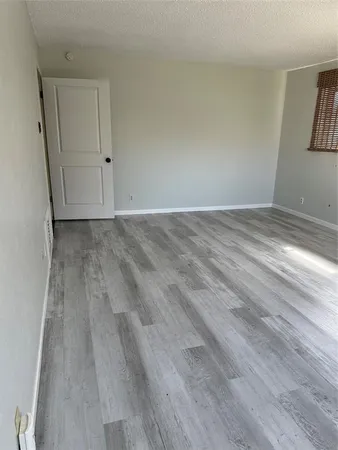 a view of a room with wooden floor