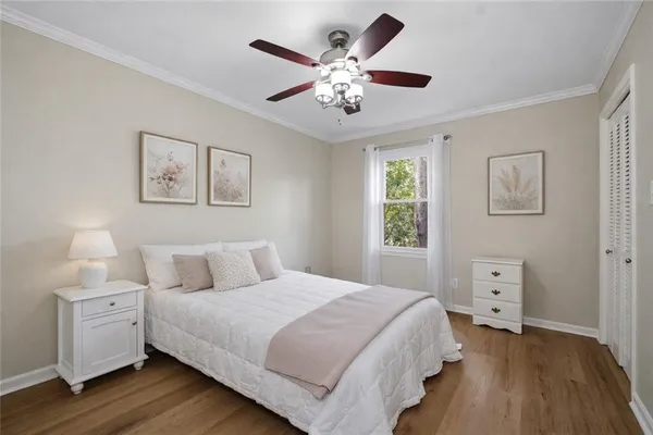 a bedroom with a large bed and a chandelier